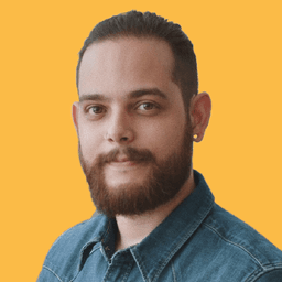 A headshot of a professional bearded man