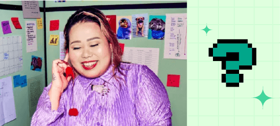 A person at their desk, smiling and talking on the phone