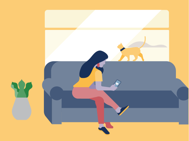 a woman sitting on a couch with a dog in the background.